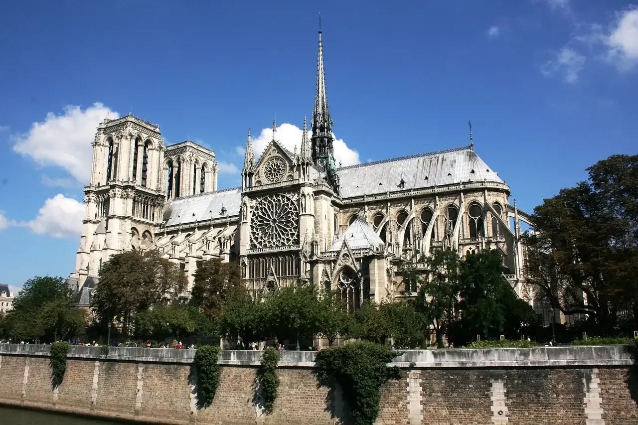Notre-Dame de Paris and its spire seen from the bank of the Seine