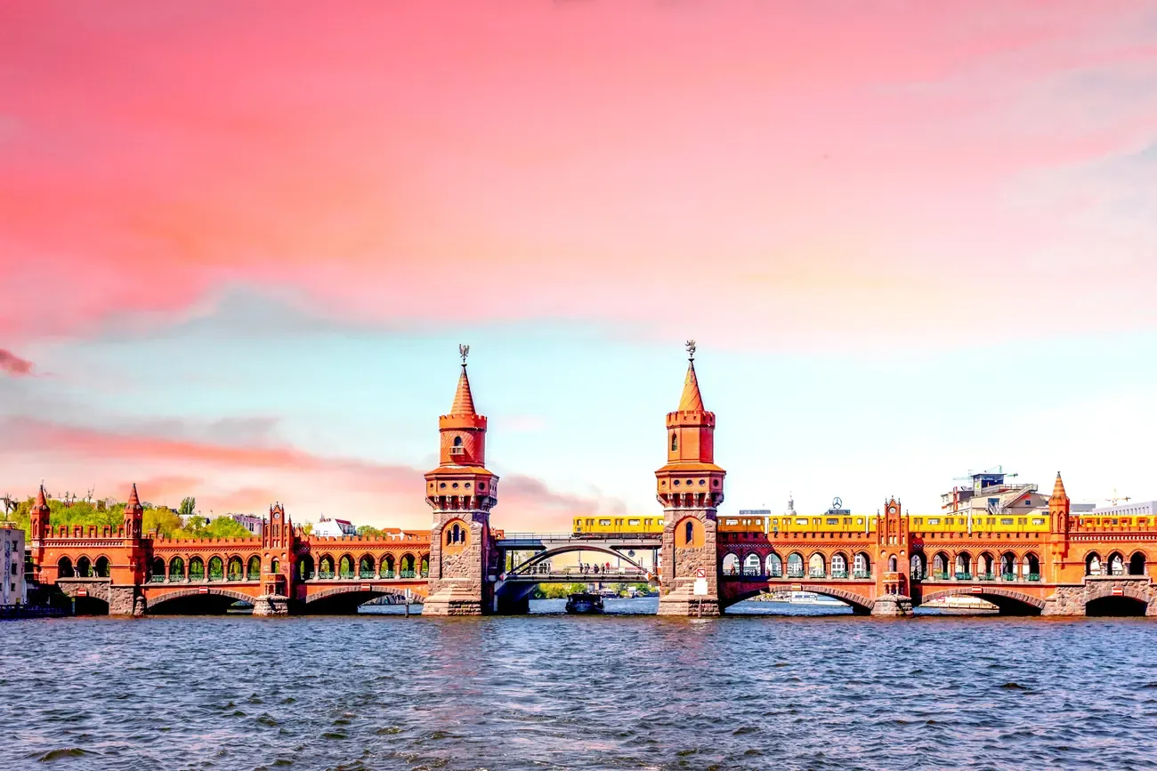 The Oberbaum Bridge spanning the Spree under a pink evening sky in Berlin