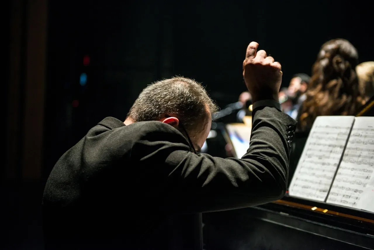 A conductor leading an orchestra