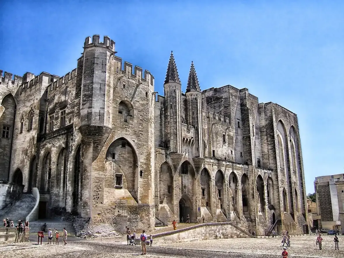 The Gothic facade of the Palais des Papes on its square in Avignon, France