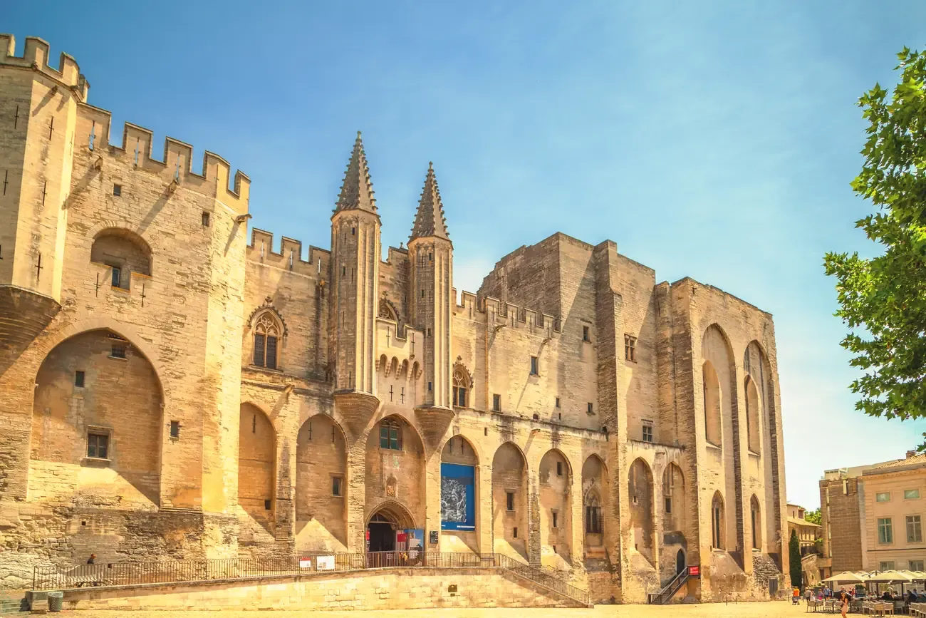 The Gothic facade and twin turrets of the Palais des Papes in Avignon, Provence