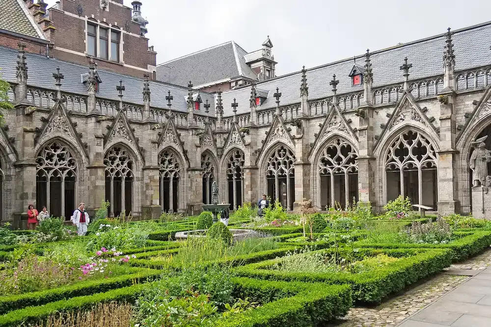 The herb beds and Gothic cloister arcade of the Pandhof garden beside the Domkerk in Utrecht