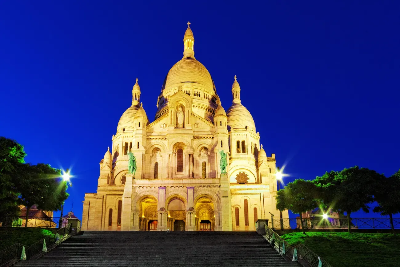 The Sacre-Coeur basilica on Montmartre hill in Paris at dusk