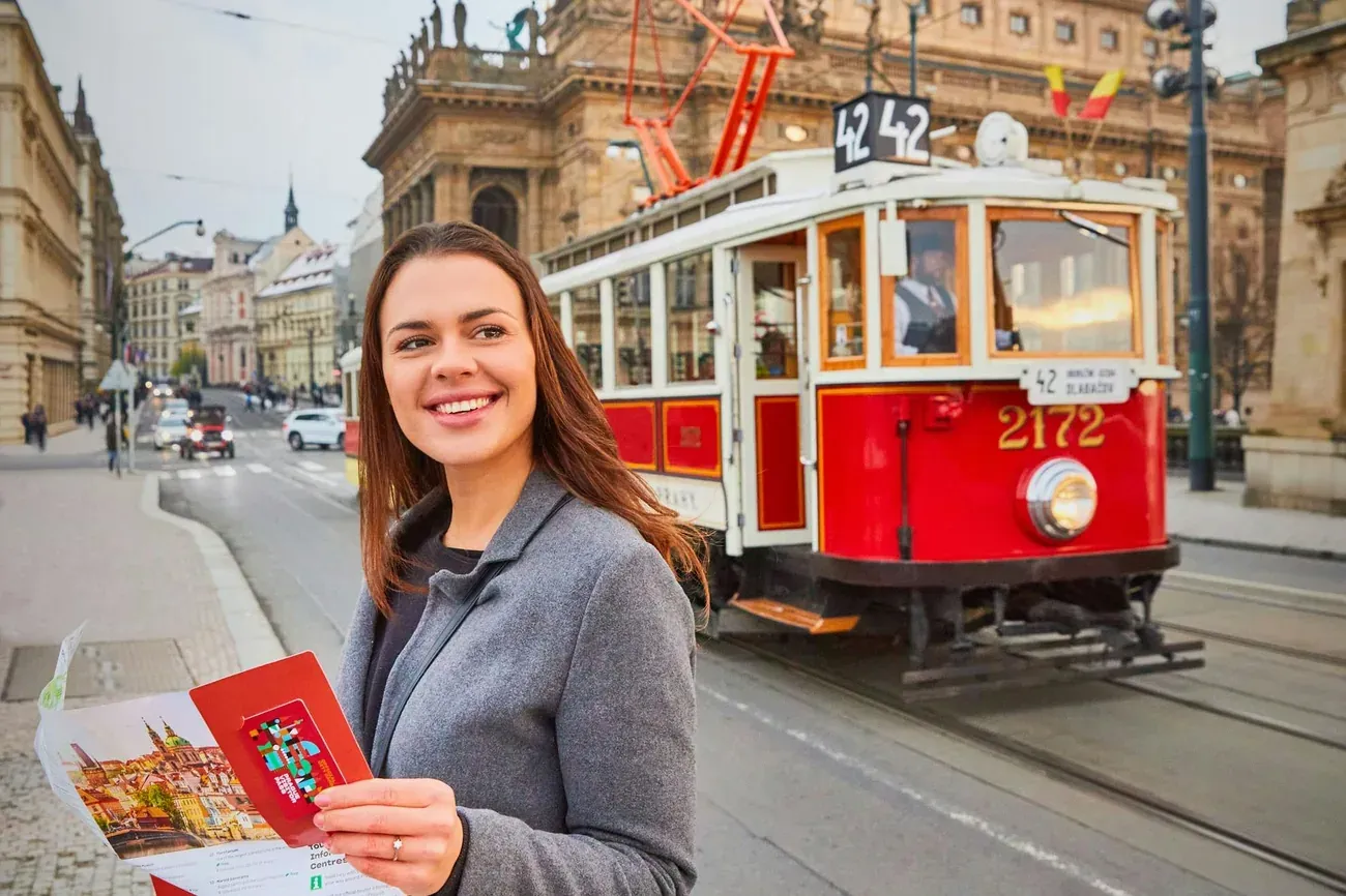A pass holder standing beside the historical line 42 tram in Prague