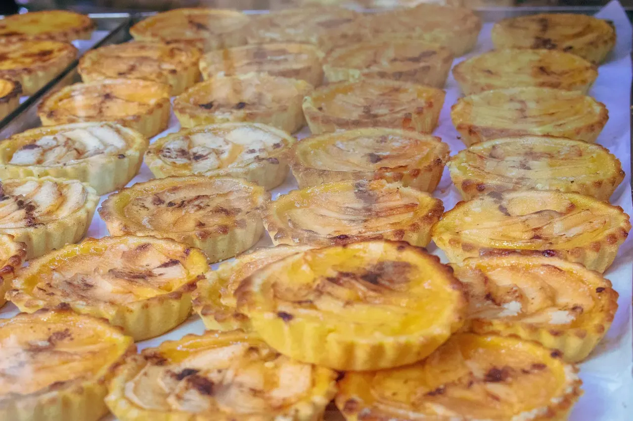 A tray of pasteis de nata with caramelised custard tops