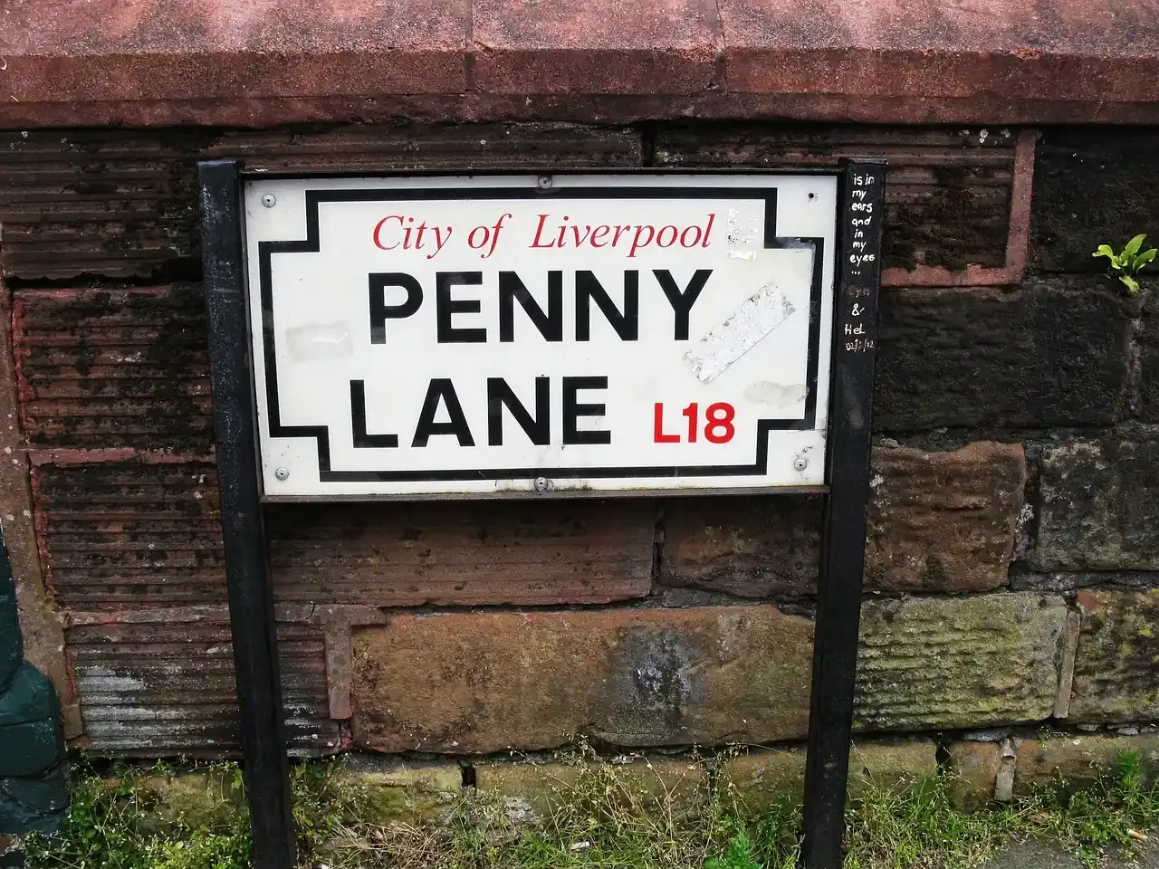 The Penny Lane street sign on a brick wall in Liverpool