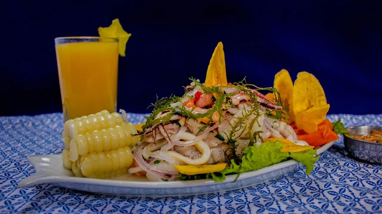 A plate of Peruvian ceviche served with corn, sweet potato and chifles