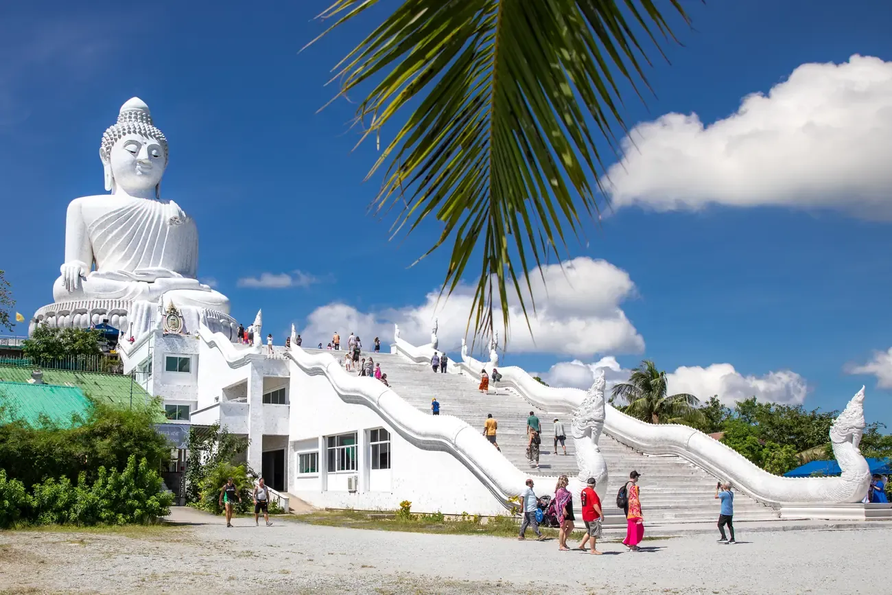 The white marble Big Buddha of Phuket above its naga staircase