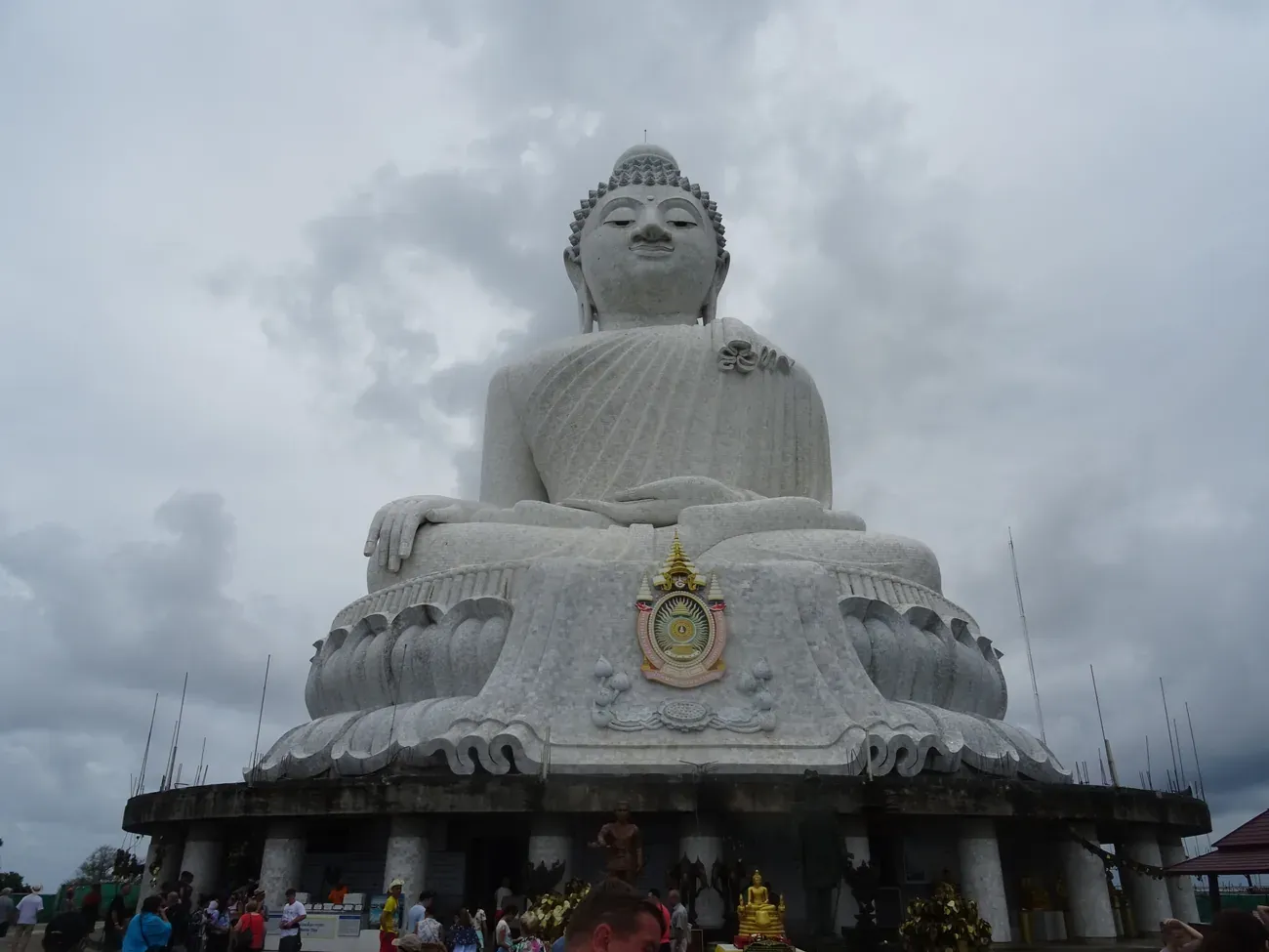 The Big Buddha of Phuket seated on its lotus base with a royal emblem