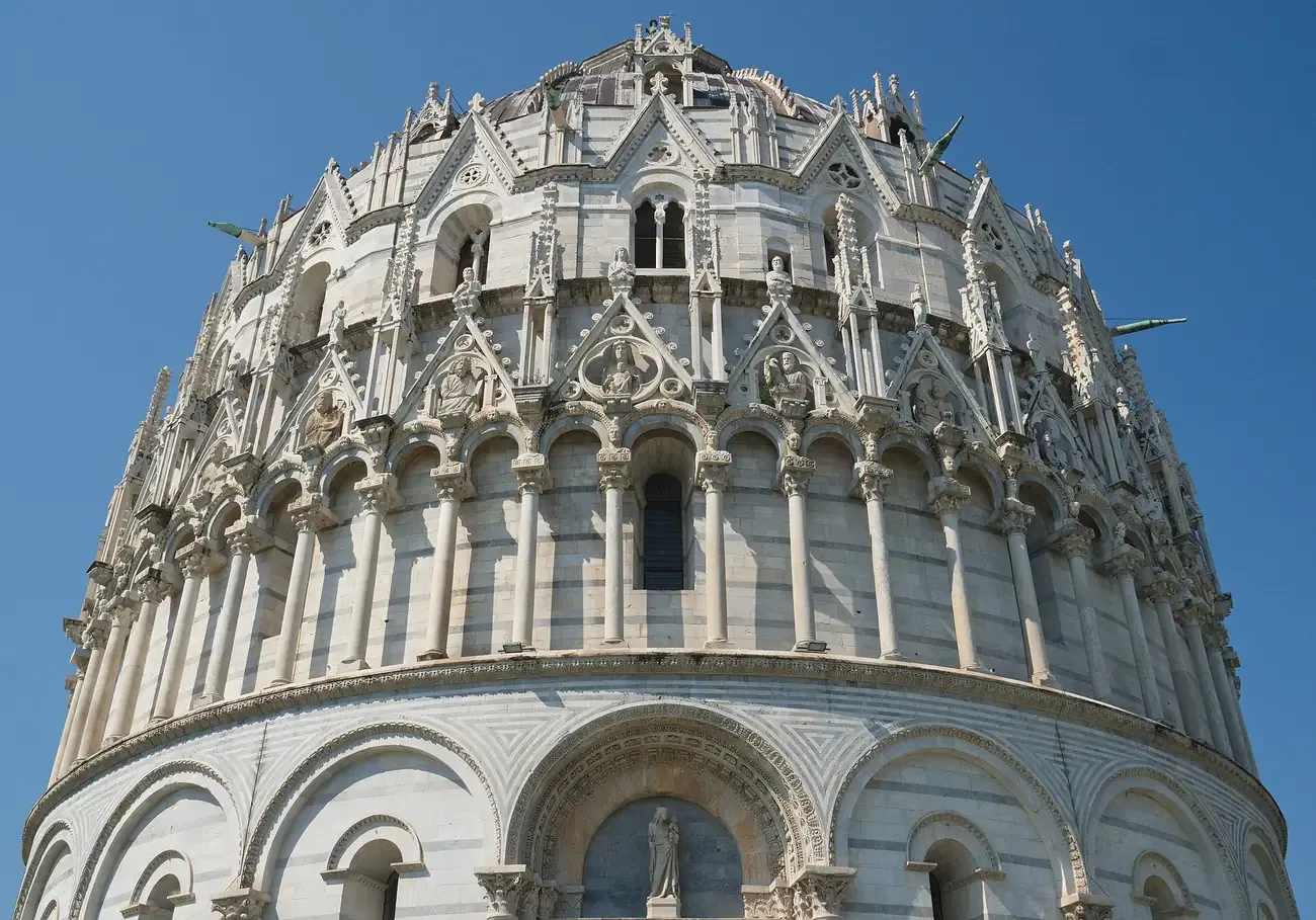Gothic gables and statues on the upper tiers of the Pisa Baptistery above the main portal