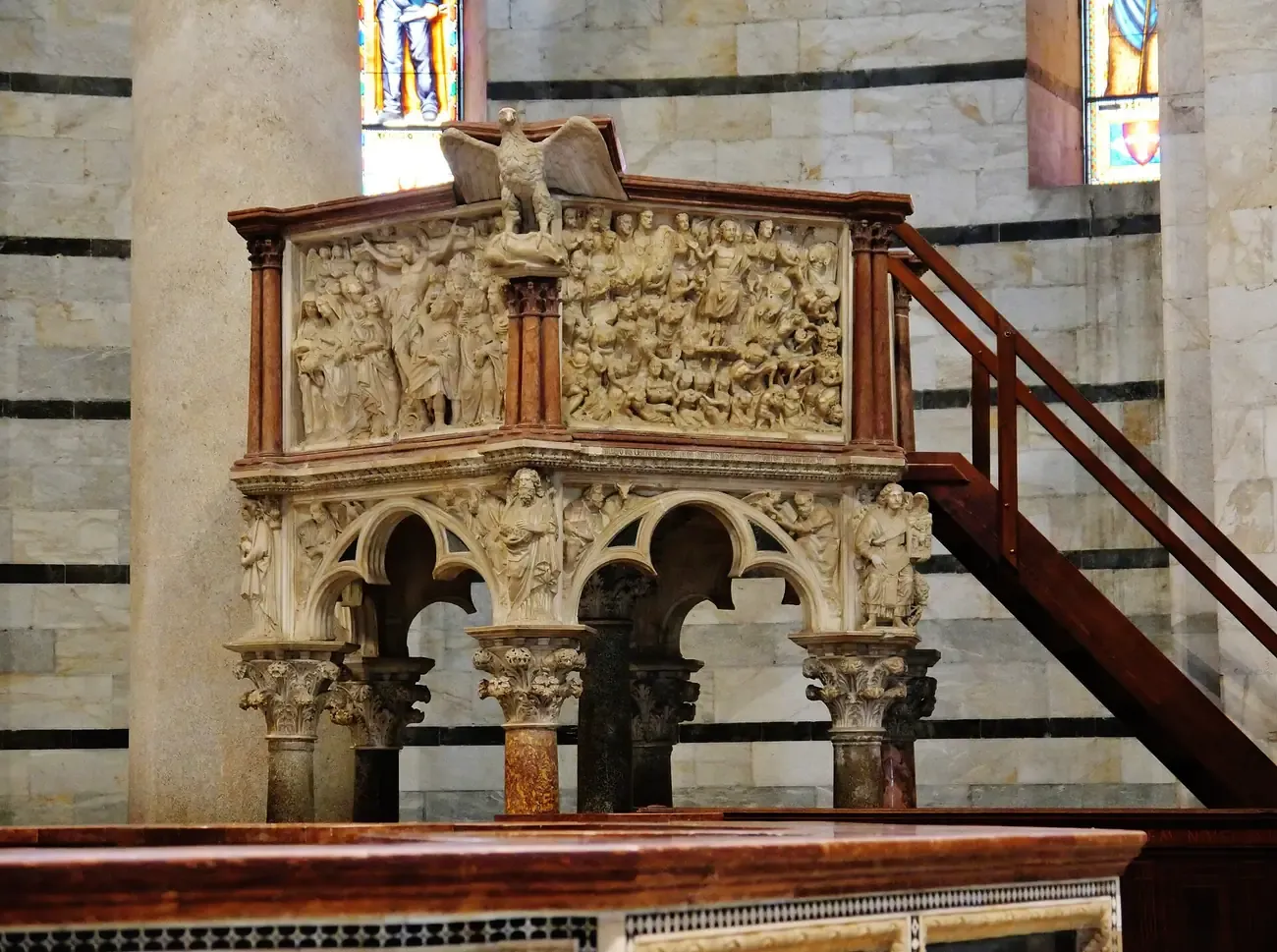 The carved marble pulpit by Nicola Pisano inside the Pisa Baptistery