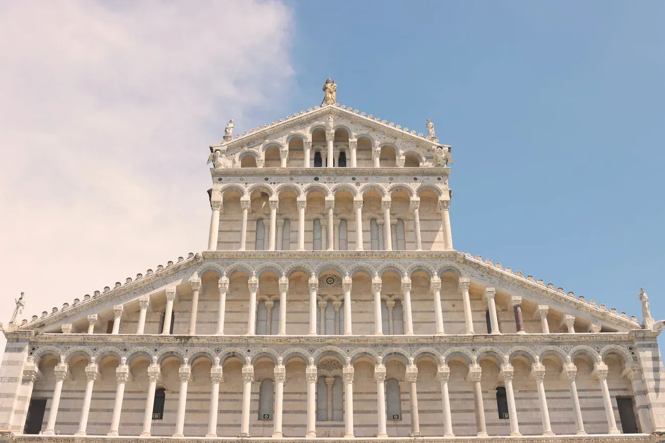 Front view of the white marble Romanesque facade of Pisa Cathedral