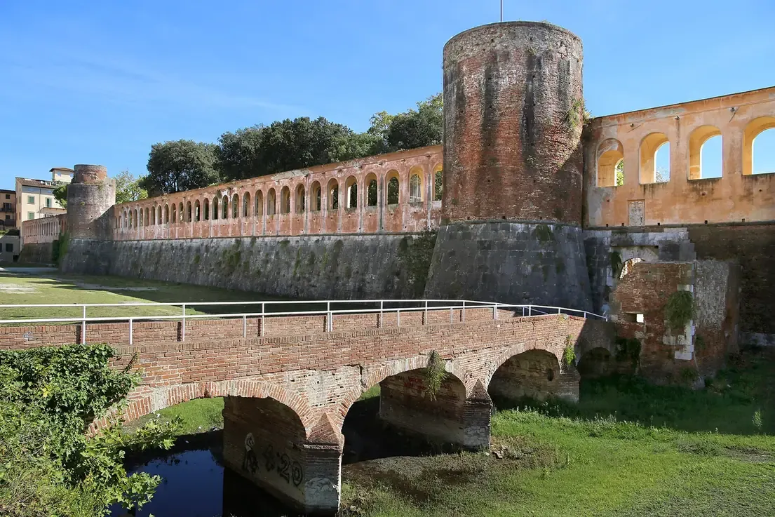The walls and round tower of the Cittadella Nuova that enclose Giardino Scotto in Pisa