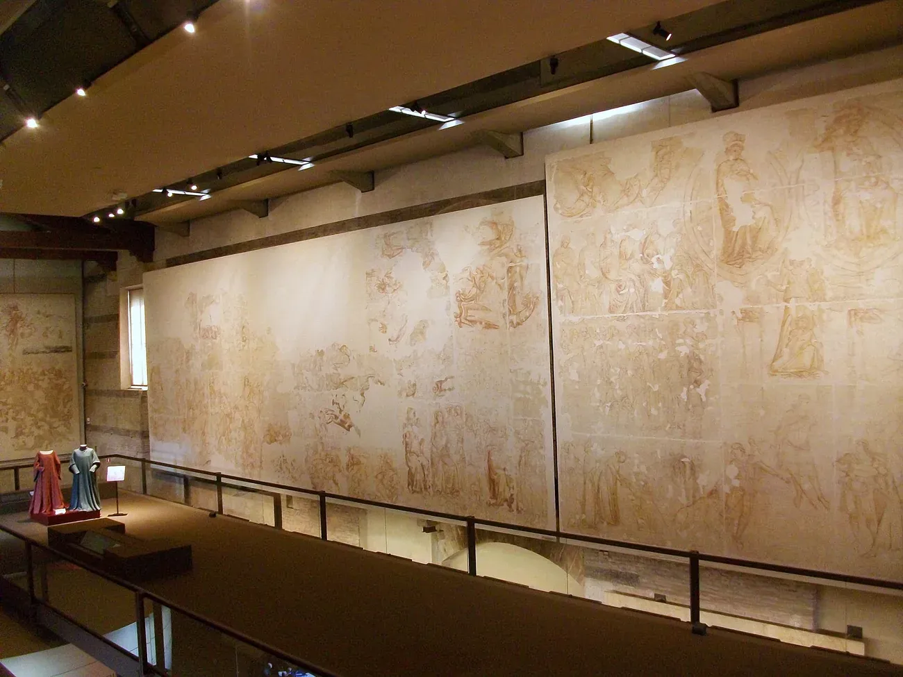 The large red-ochre fresco underdrawings displayed inside the Museo delle Sinopie in Pisa