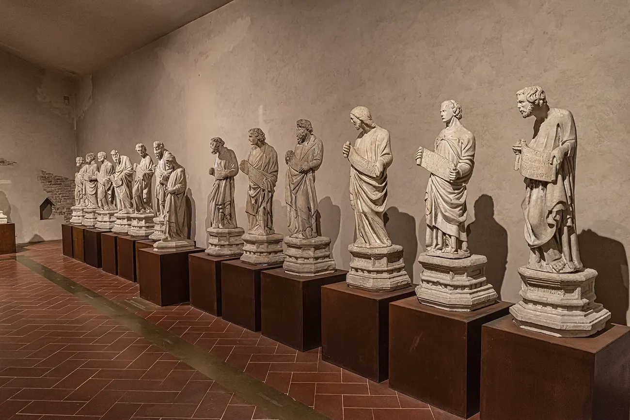 A row of medieval marble statues in the National Museum of San Matteo in Pisa