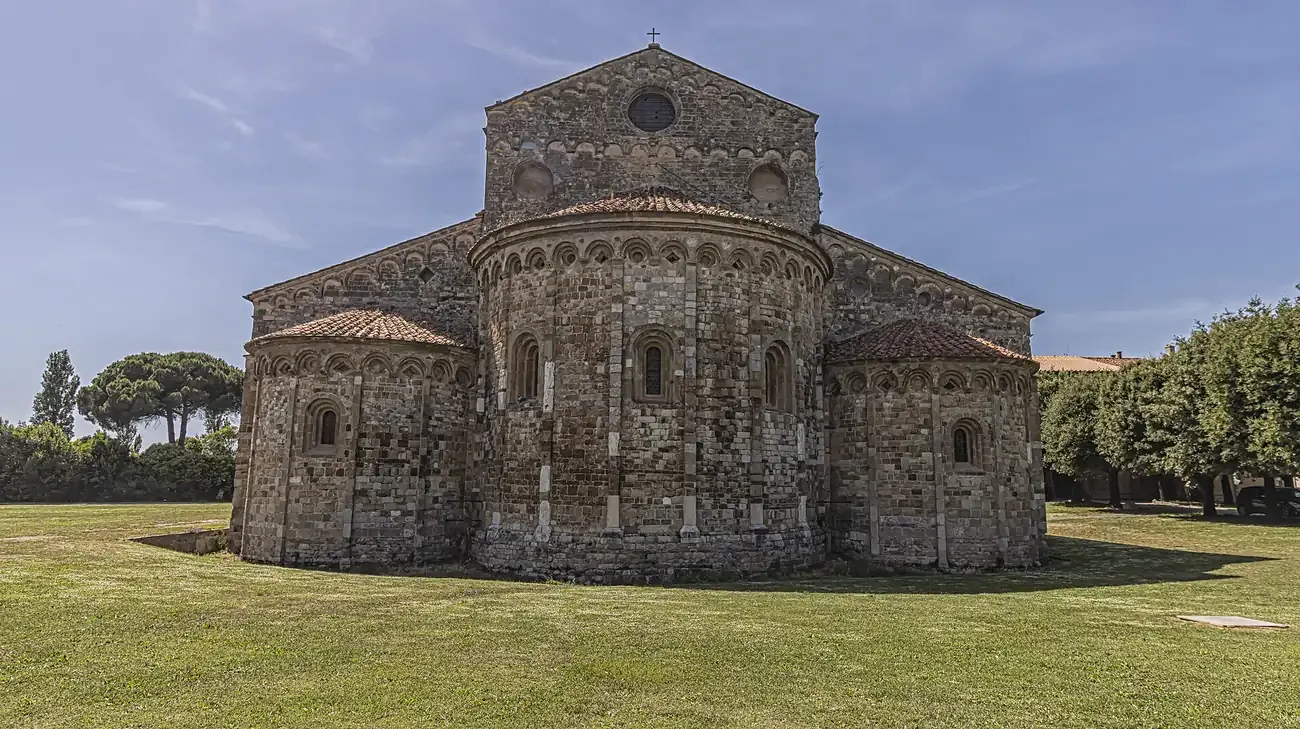The Romanesque basilica of San Piero a Grado near Pisa seen across the lawn