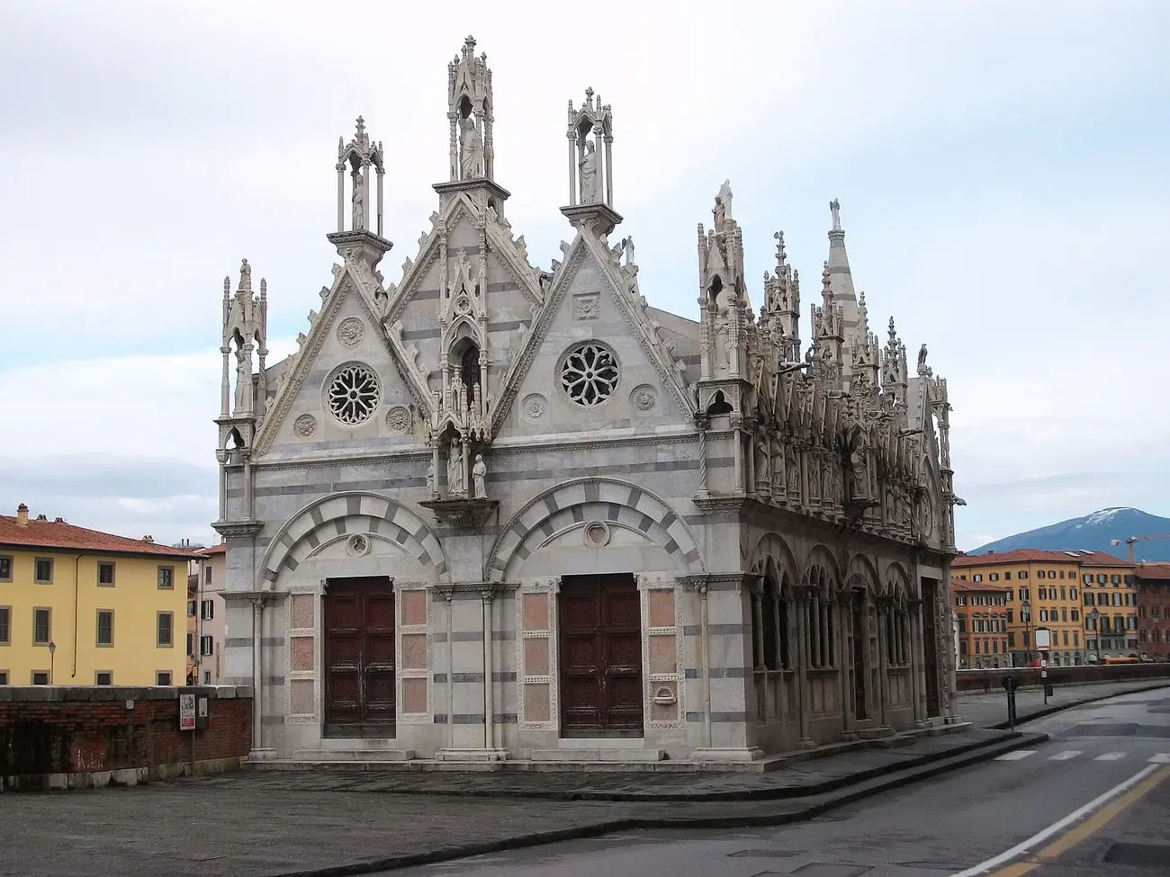 The pinnacled Gothic marble facade of Santa Maria della Spina in Pisa