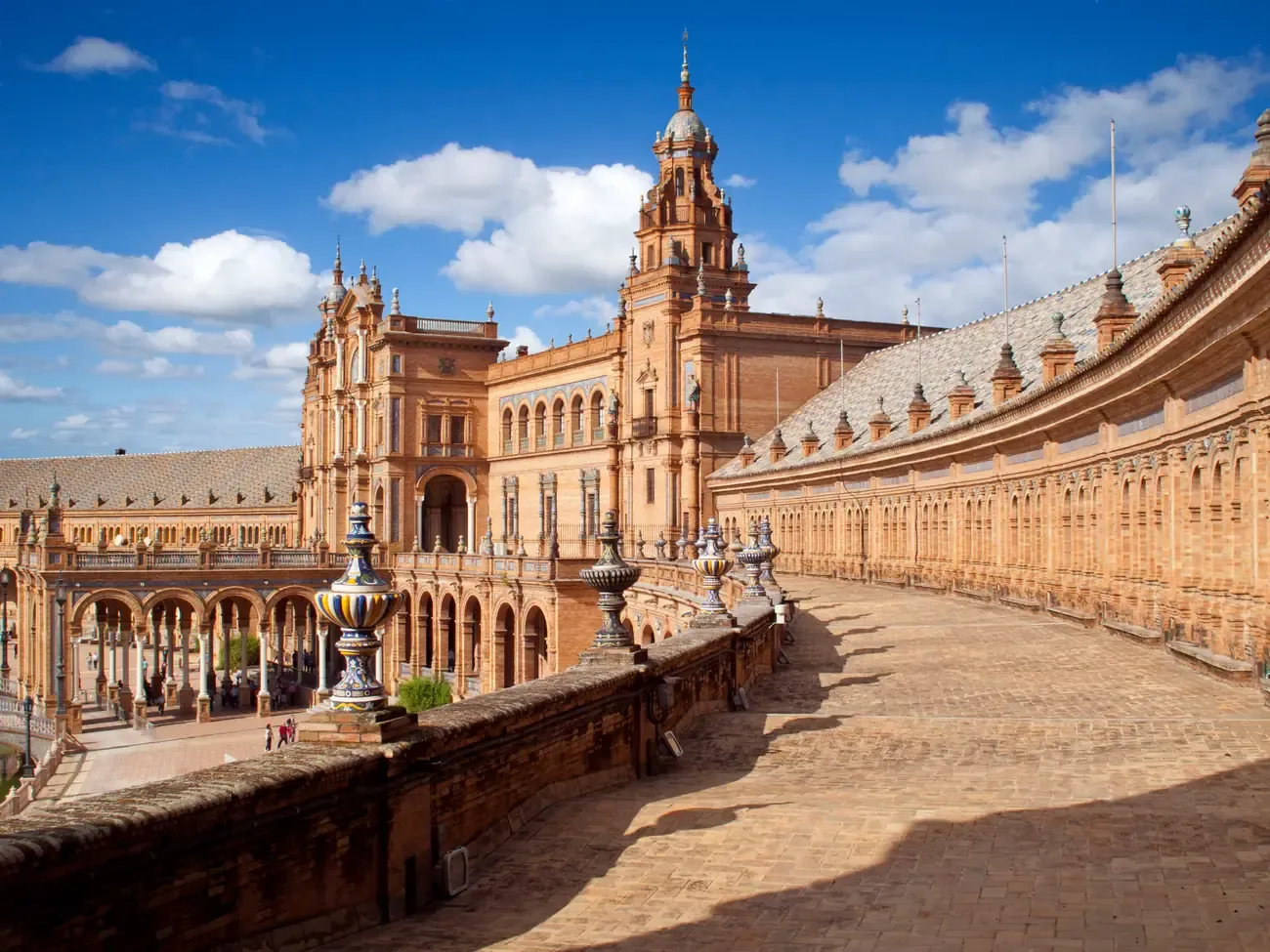 The curved arcade and tower of Plaza de Espana in Seville
