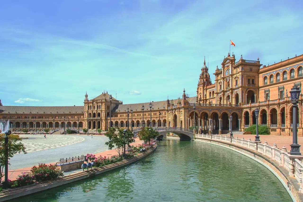 The canal, bridge and semicircular palace of Plaza de Espana in Seville, Spain