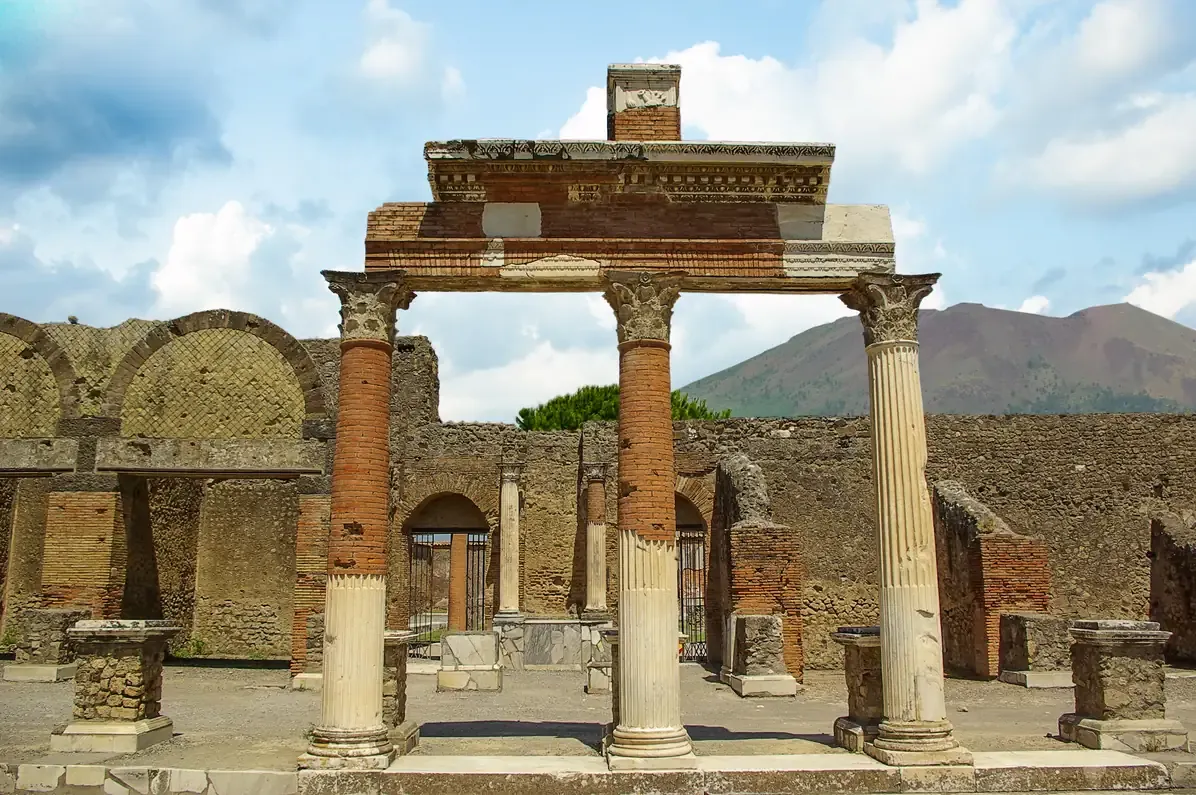 Surviving columns of the forum of Pompeii with Mount Vesuvius rising behind