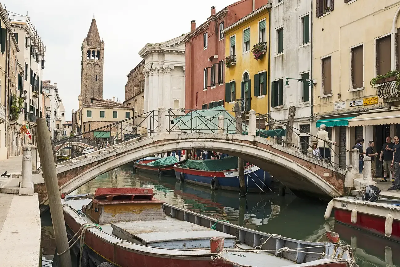 The Ponte dei Pugni arching over the canal near Campo San Barnaba in Venice, with the San Barnaba bell tower behind