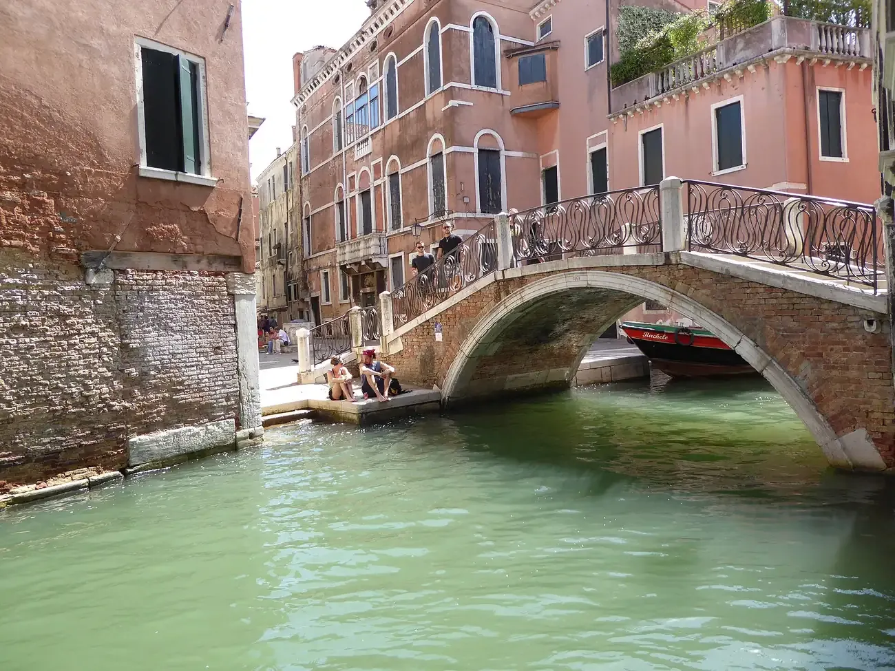 The arched Ponte San Canciano with its wrought-iron railings over a canal in Cannaregio, Venice
