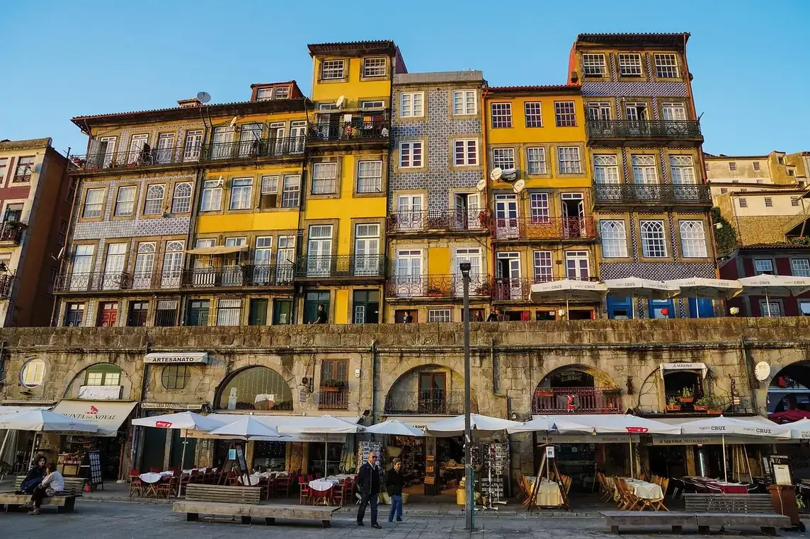 Painted facades and arcades along the Ribeira quay in Porto