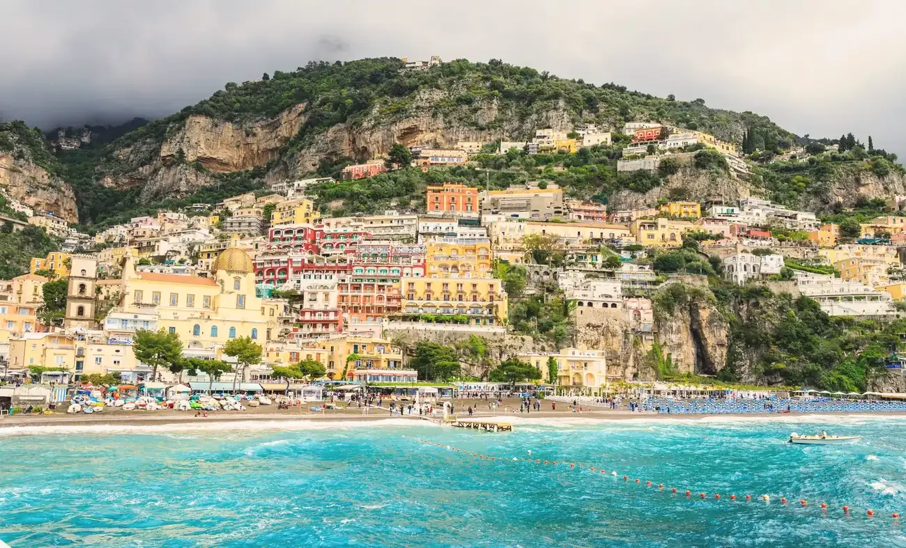 Vibrant seaside view of Positano's colorful hillside buildings above the Mediterranean