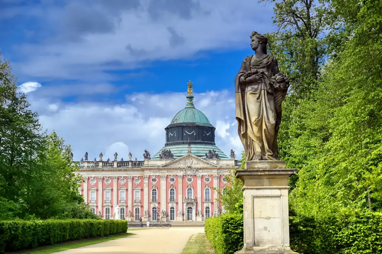 The New Palace in Sanssouci Park seen from its garden, with a statue in the foreground, Potsdam, Germany