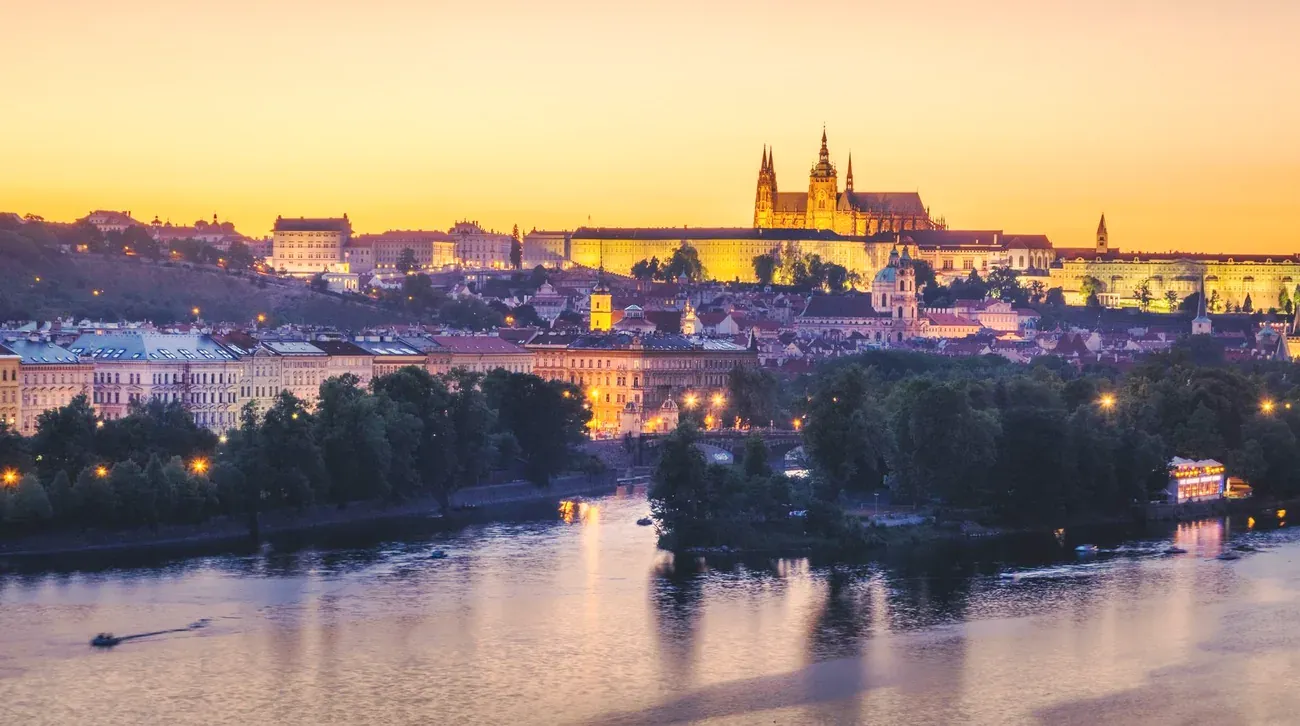 Prague Castle glowing at sunset above the Vltava