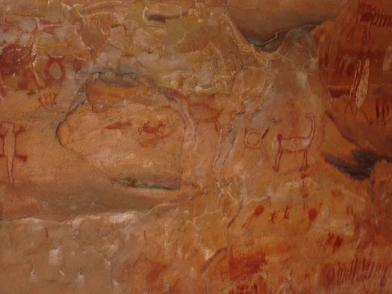 Red prehistoric figures painted on a rock wall in Serra da Capivara, Piaui