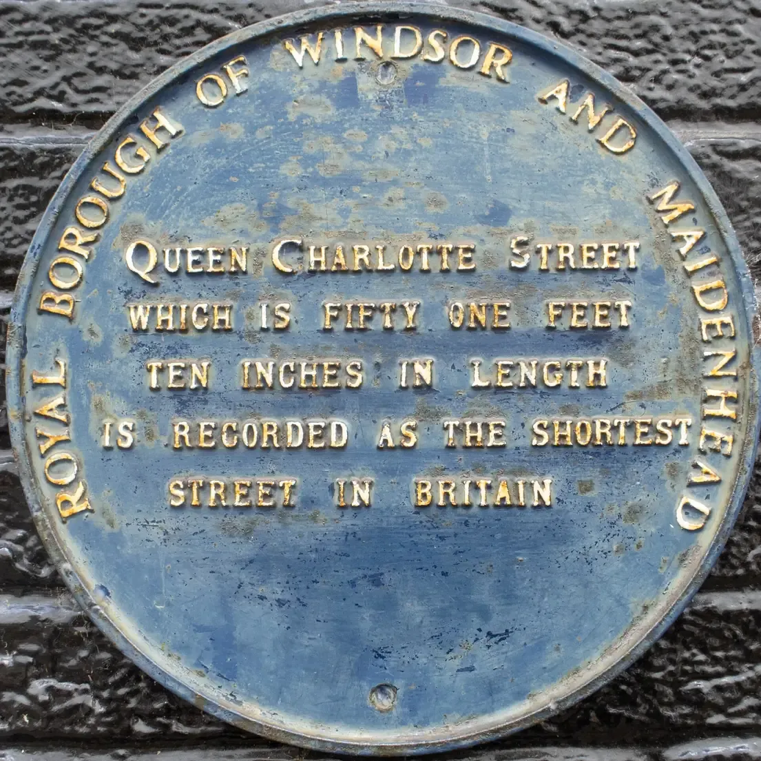 The blue plaque on Queen Charlotte Street in Windsor recording it as the shortest street in Britain at fifty one feet ten inches