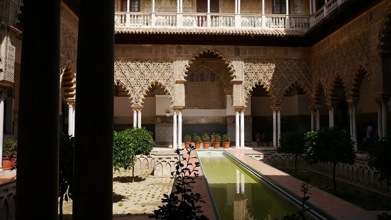 The reflecting pool and arcades of the Patio de las Doncellas at the Real Alcazar of Seville