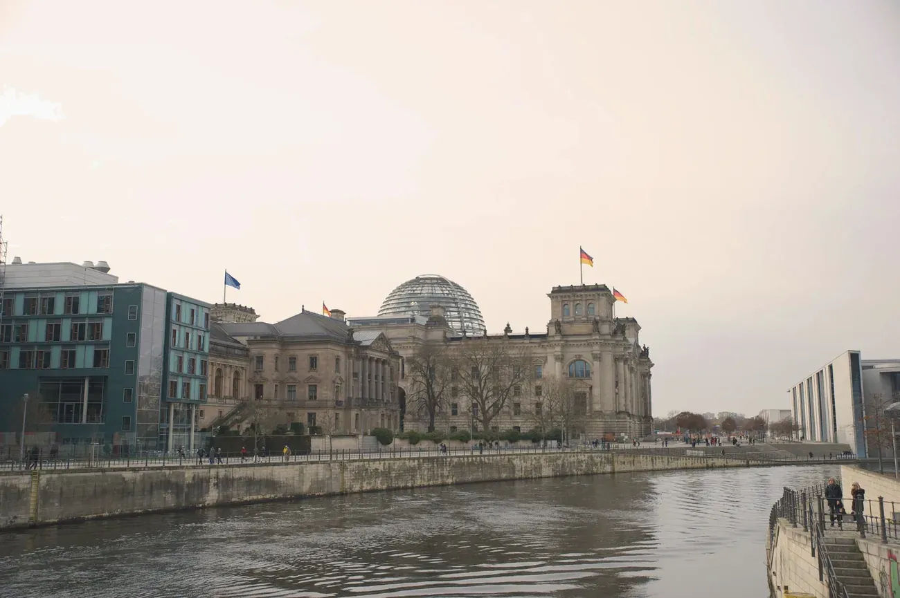 The Reichstag building in Berlin seen along the Spree river