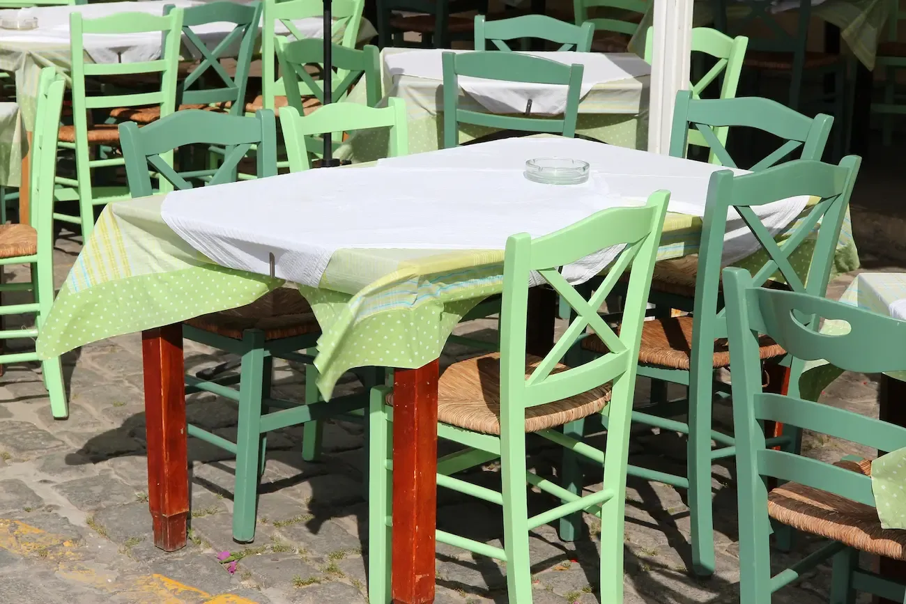 restaurant tables and green chairs athens