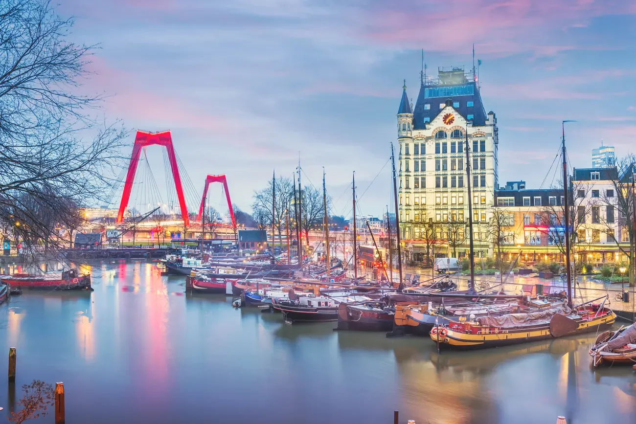 The historic Witte Huis and Willemsbrug bridge in Rotterdam's Oude Haven at twilight