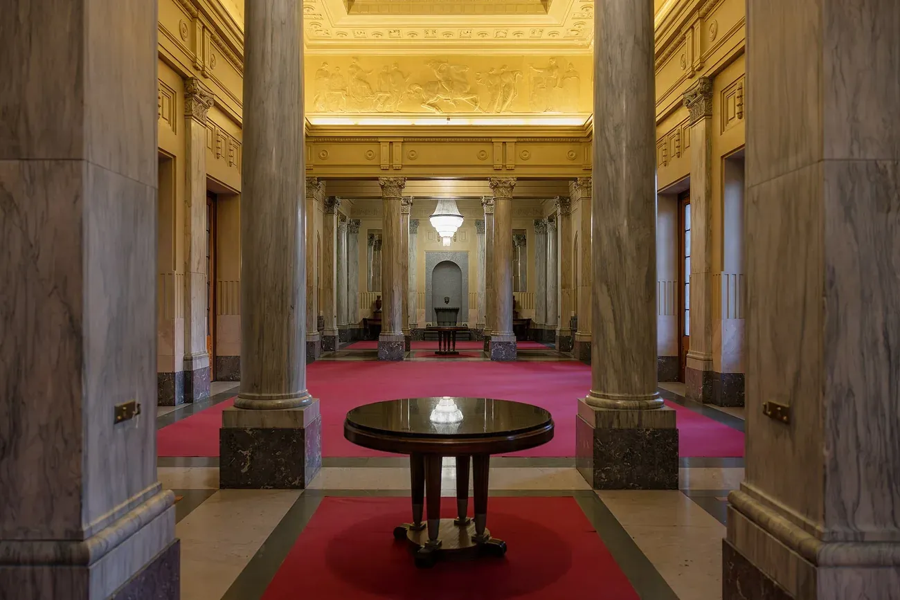 Marble columns and red carpet in the Royal Hall of the Royal Pavilion at Milano Centrale station in Milan