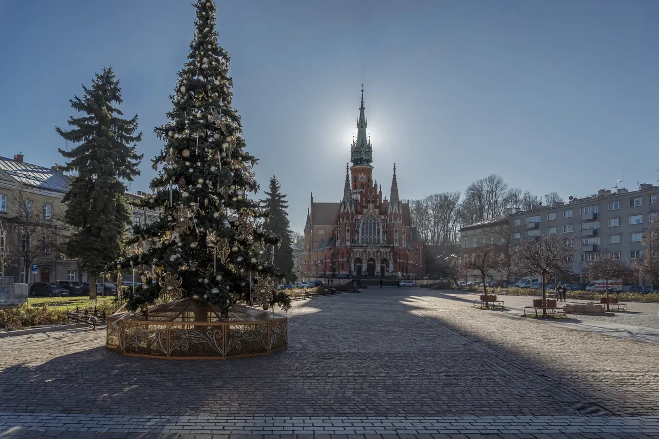 The Christmas tree on Podgórze Market Square in Krakow, with the neo-Gothic St Joseph's Church behind