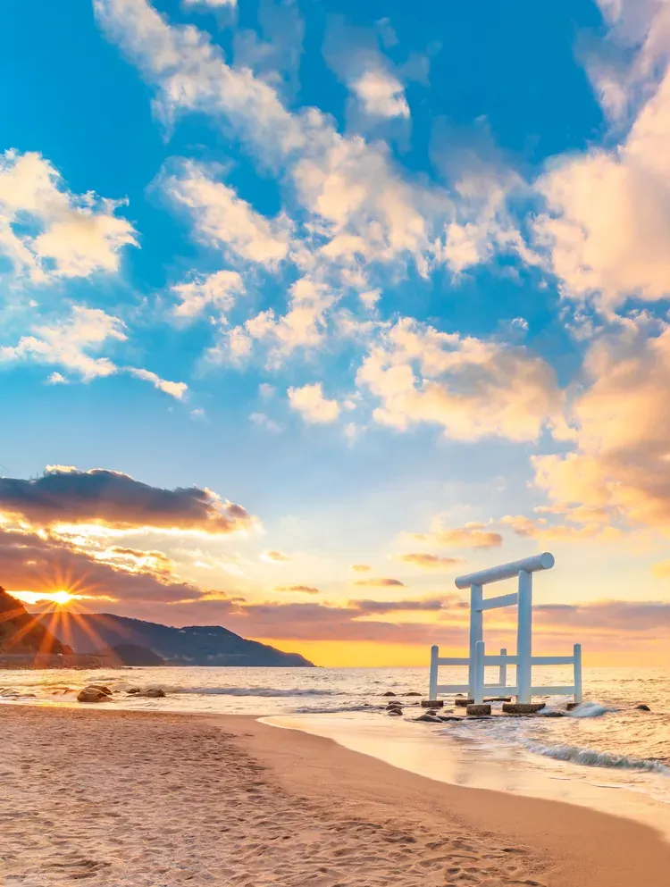 The white Sakurai Futamigaura torii gate on the beach at sunrise, Itoshima, Fukuoka