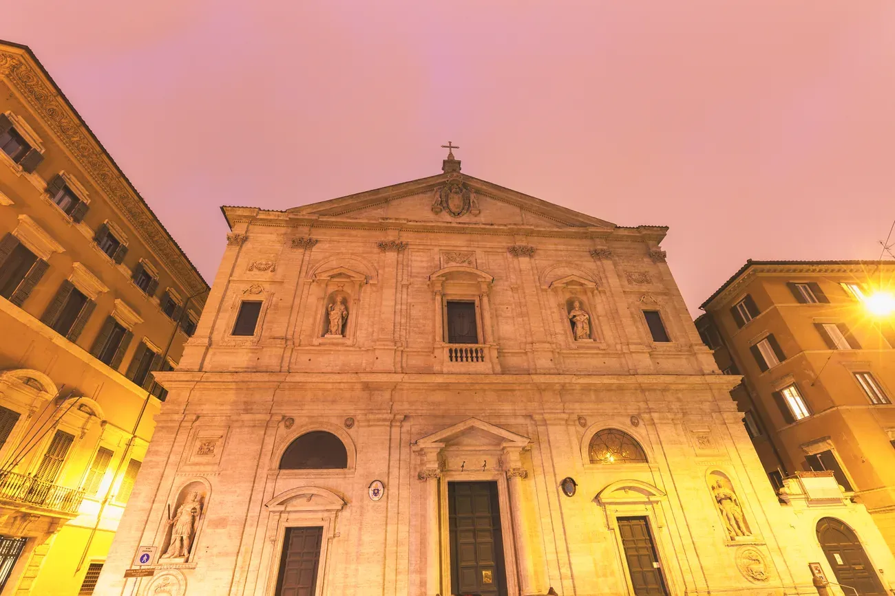 The travertine facade of San Luigi dei Francesi at dusk in Rome