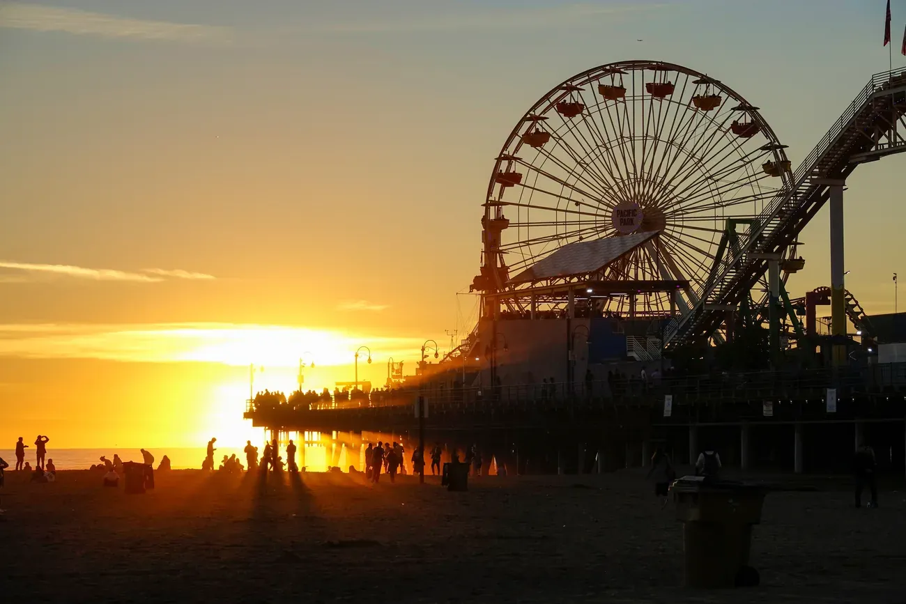 The Santa Monica Pier Ferris wheel glowing at sunset near Los Angeles