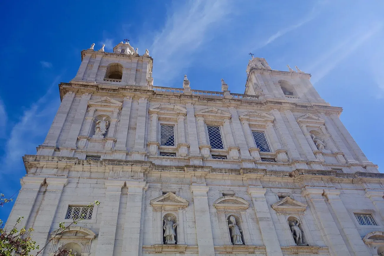 The white Baroque facade of the Sao Vicente de Fora monastery in Lisbon, home to the Seashell Gallery