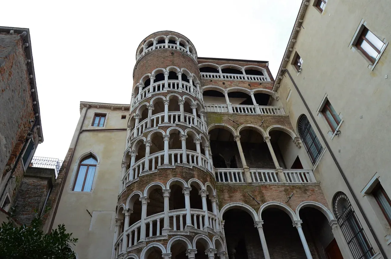 The spiral staircase of arches and the loggias of the Scala Contarini del Bovolo seen from its courtyard in Venice