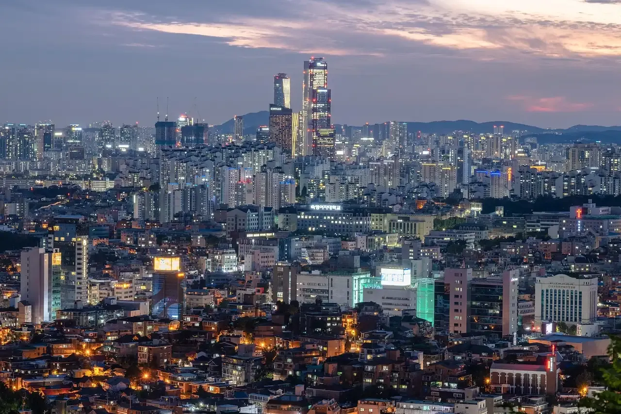 The Seoul skyline at dusk with the mountains behind the city