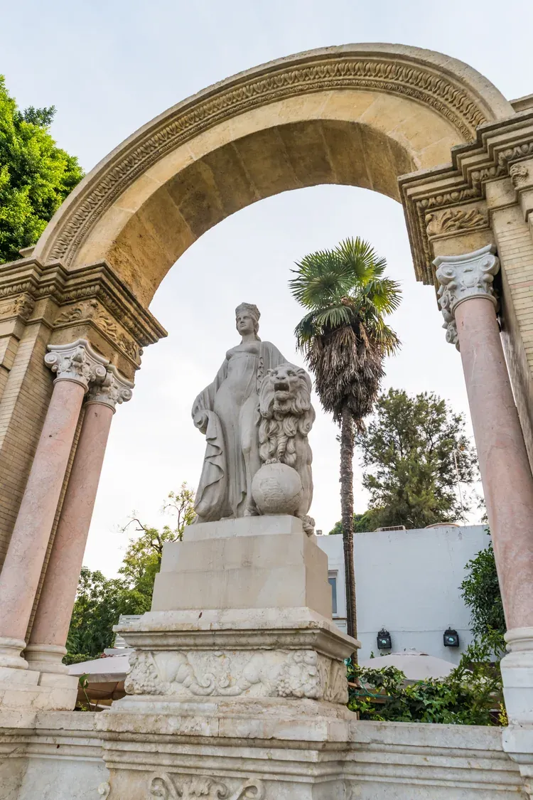Allegorical statue of Hispania with a lion beneath the arch of the Glorieta de San Diego in Seville