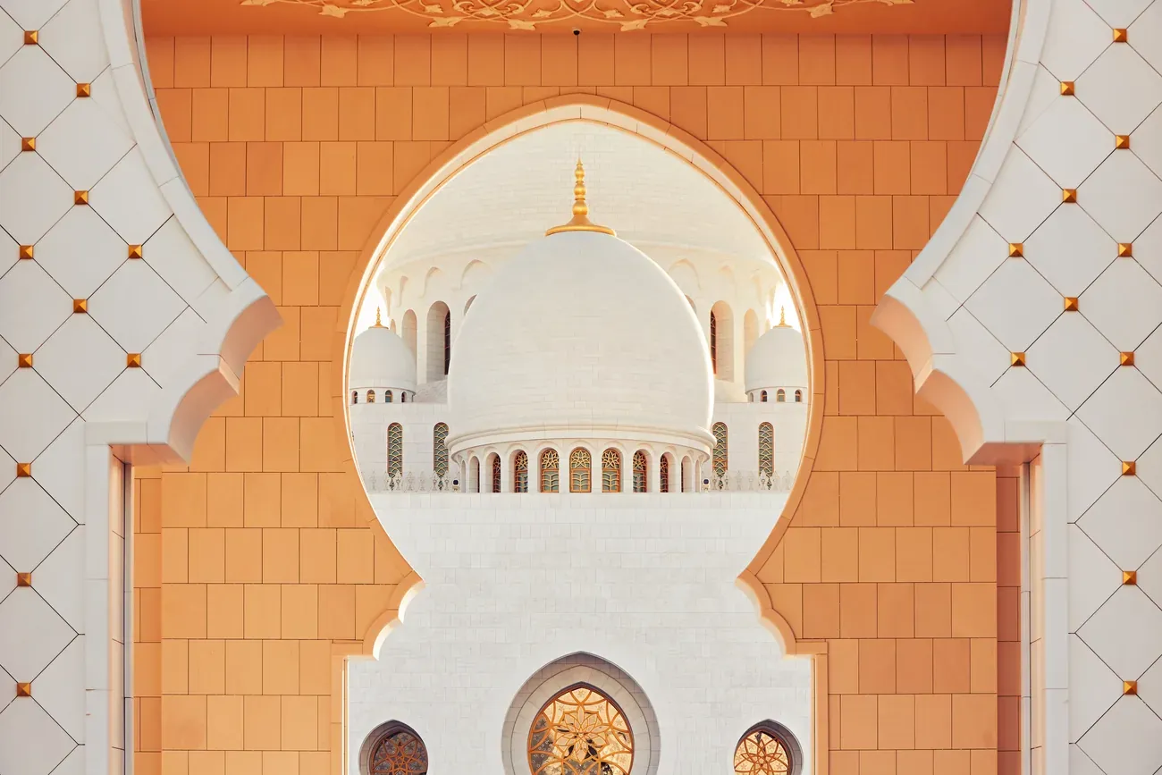 Warm-lit arch and dome detail of Sheikh Zayed Grand Mosque, Abu Dhabi