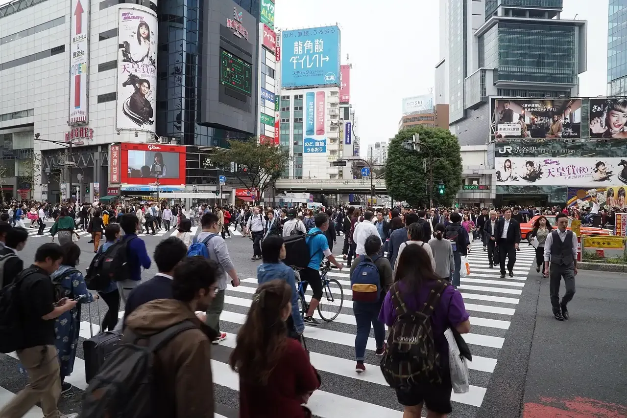 Pedestrians crossing the Shibuya scramble in daylight in Tokyo