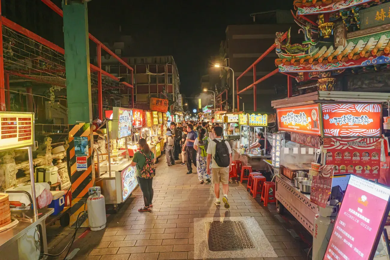 Crowds and lit food stalls along the Shilin Night Market at night, Taipei
