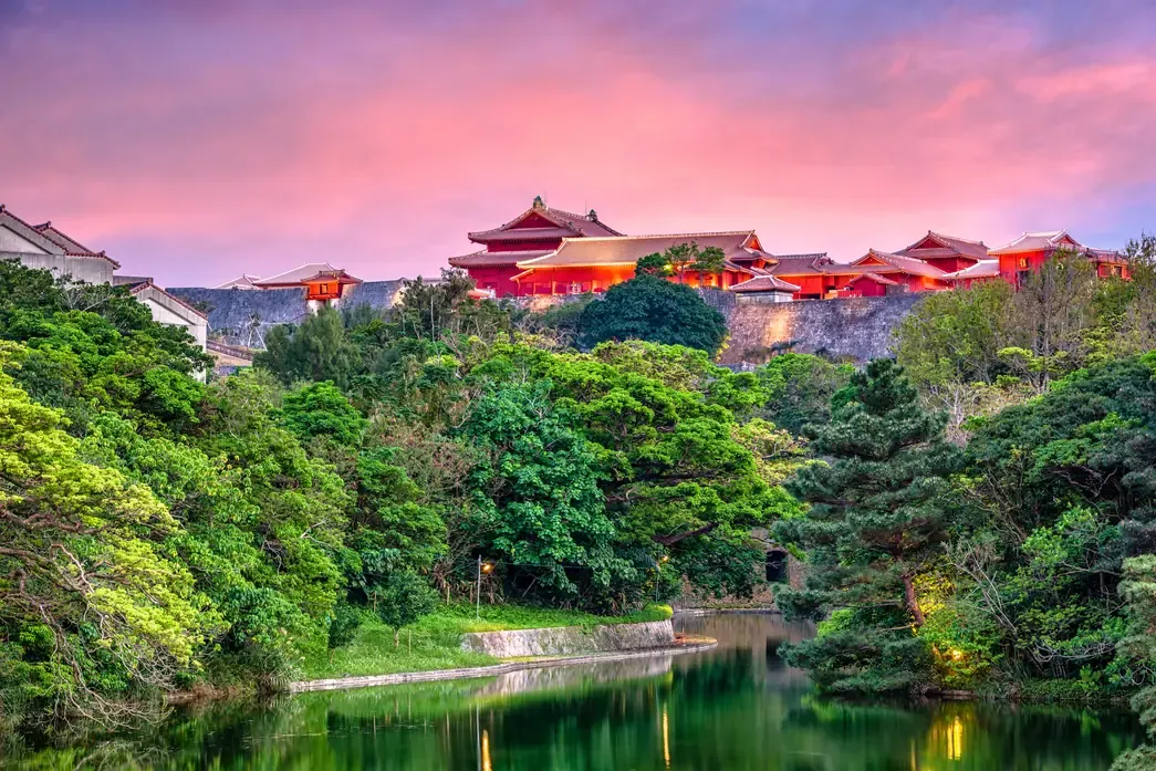 The red Shuri Castle under a pink sunset sky, Okinawa