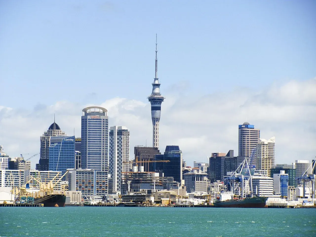 The Sky Tower rising above the Auckland skyline, seen from the harbour